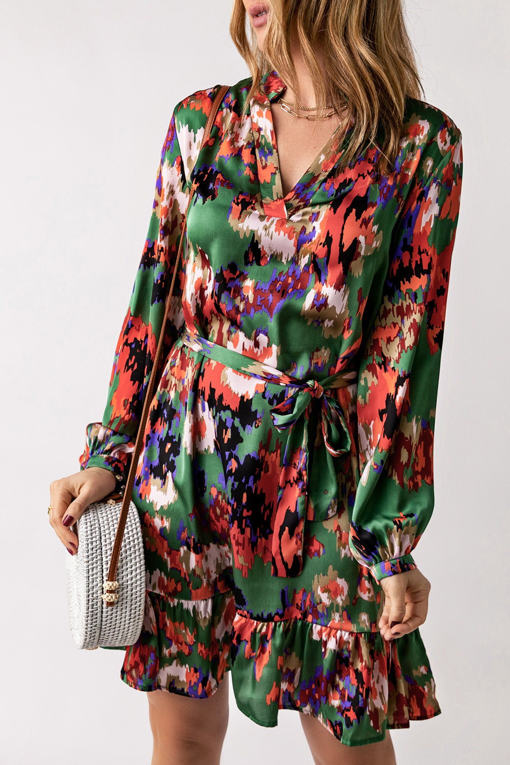 Abstract belted V Neck dress with ruffle bottom.